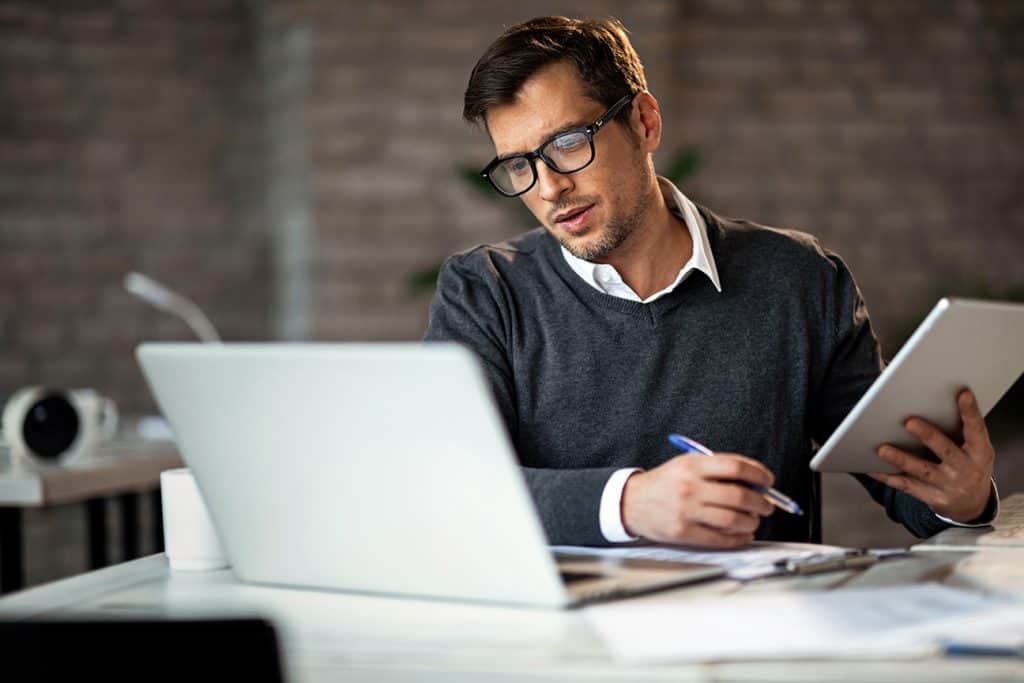 man at laptop planning out his season ticket sales